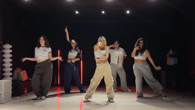 A group dancing the choreography together in the studio
